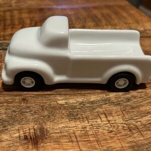 Fred porcelain/ ceramic white small truck with moveable wheels .